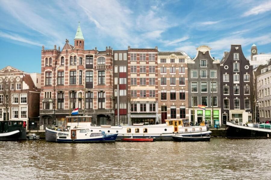 canal view of the historic facade of eden hotel rembrandtplein in Amsterdam